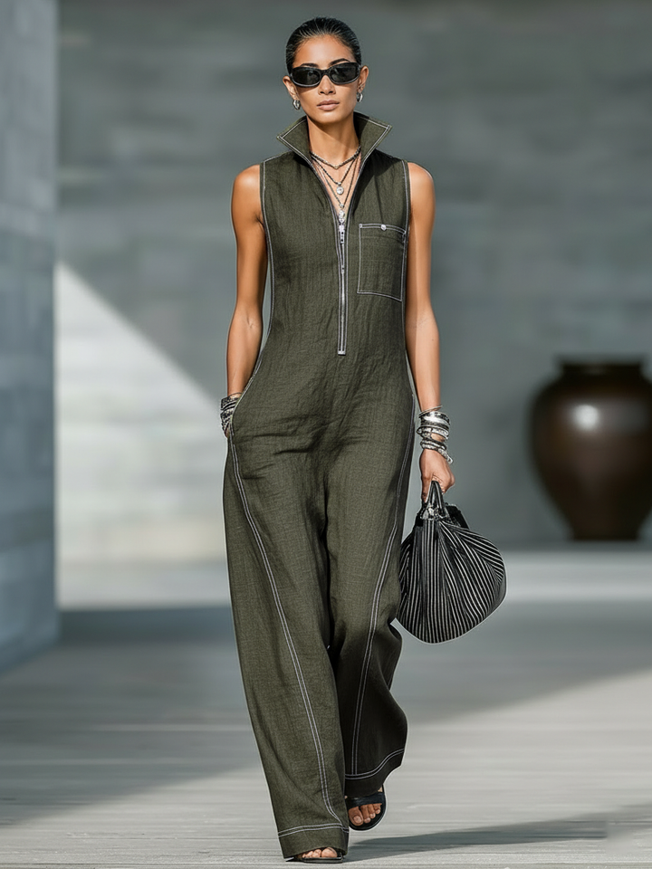 Sleeveless denim overall with white contrast trim, back view. Image 6 of 7.